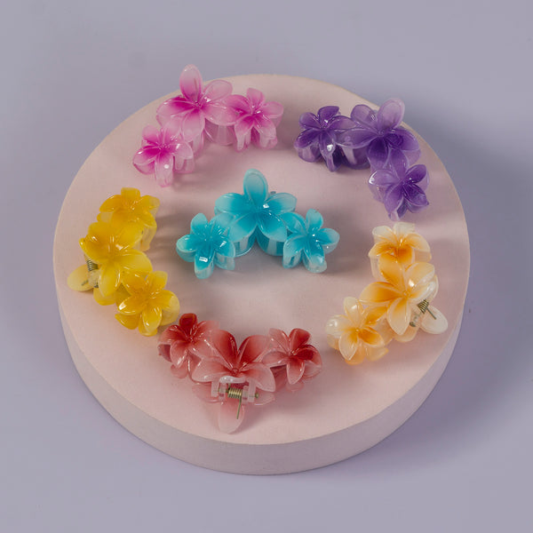 Colorful flower-shaped hair clips arranged in a circular pattern on a white base.
