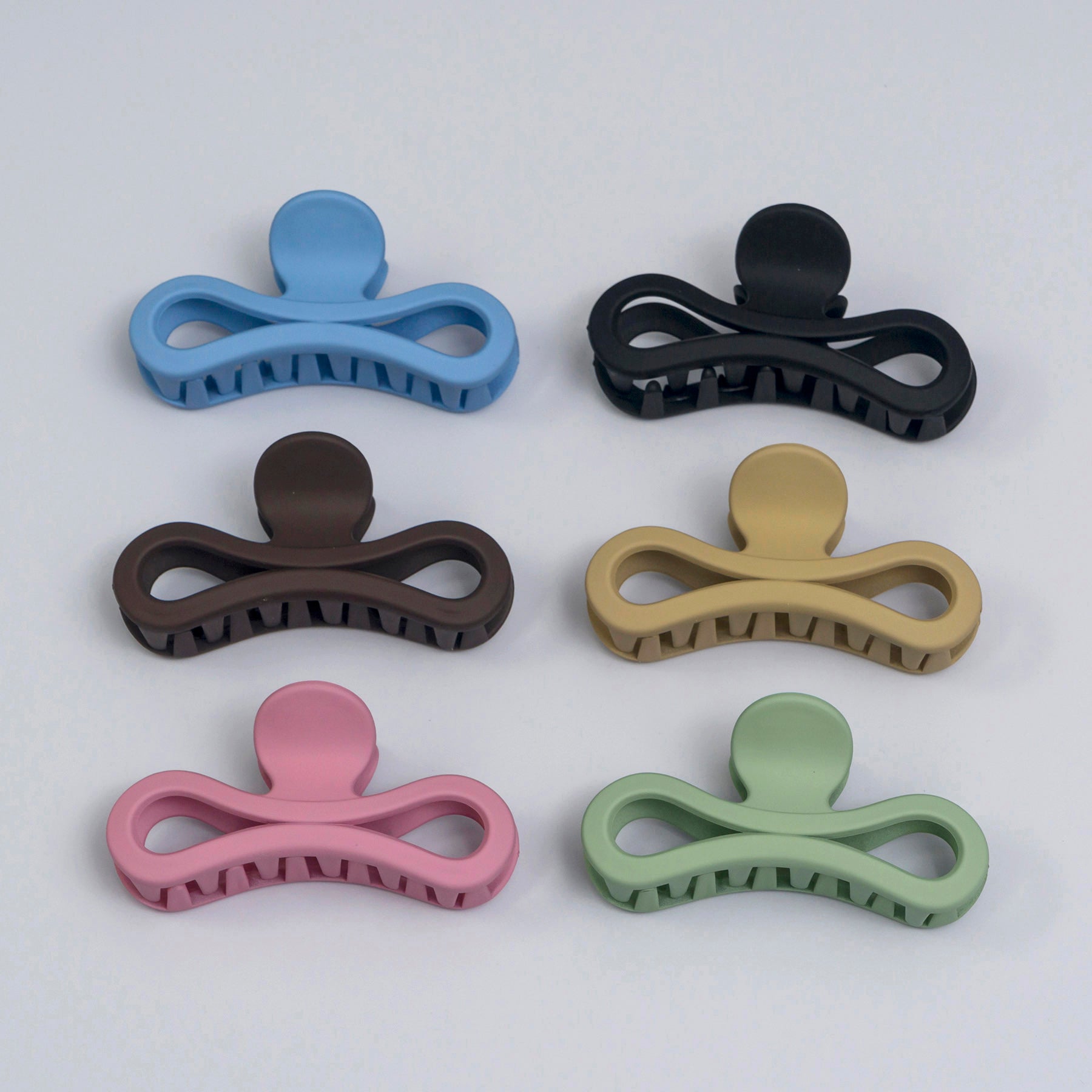 Set of six colorful hair clips on a white background