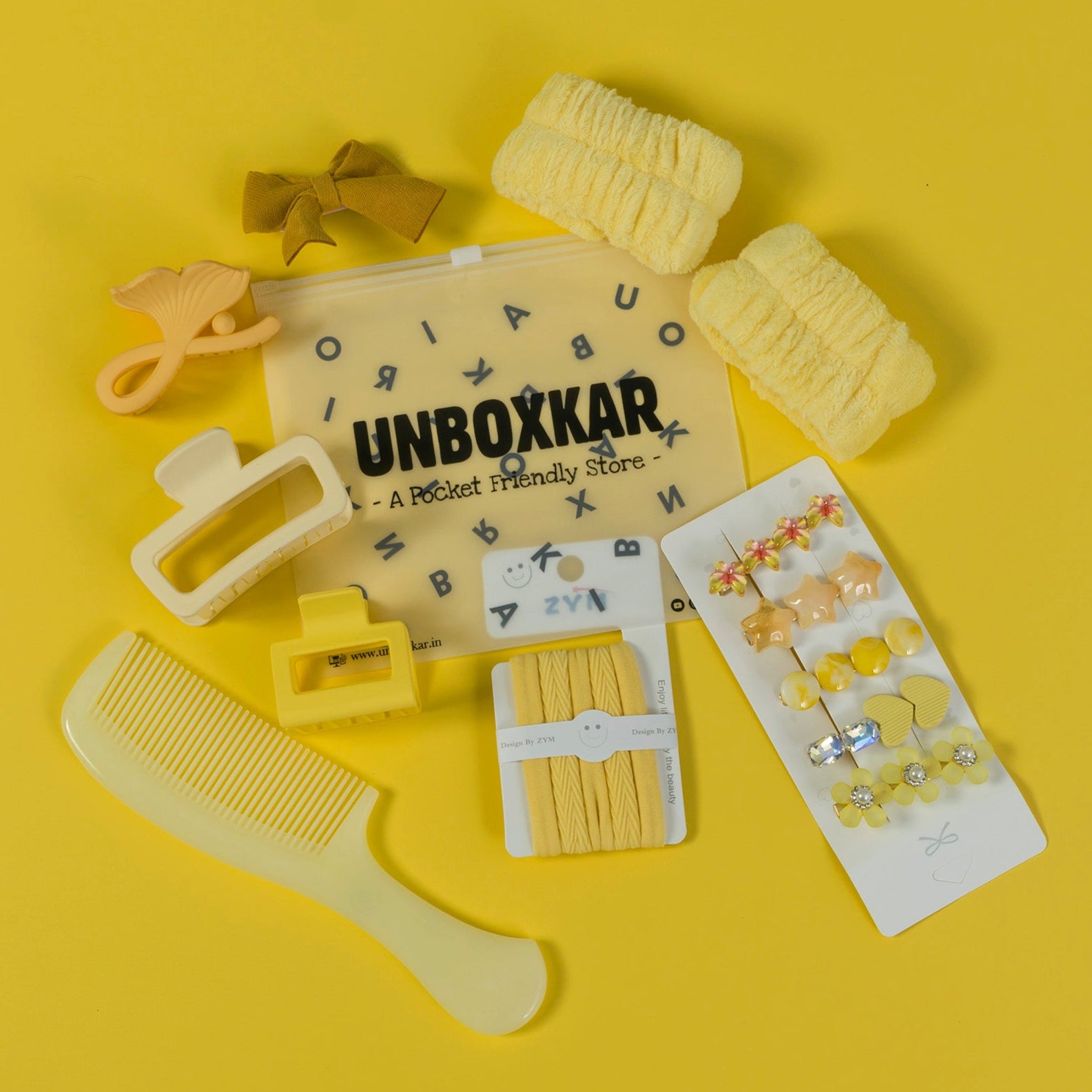 Yellow hair accessories set with 'UNBOXKAR' branding on a yellow background